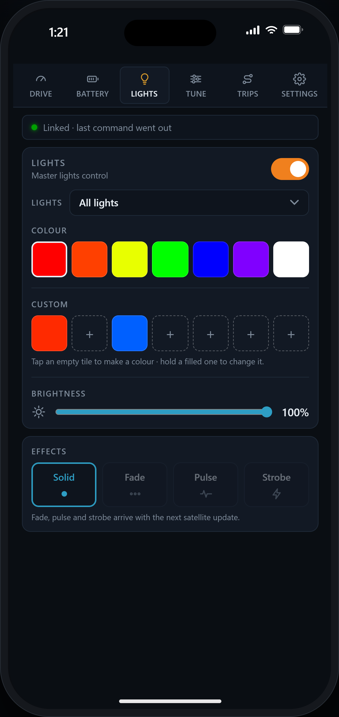 The Lights tab: on/off switch, seven preset colors, seven custom color tiles and a brightness slider